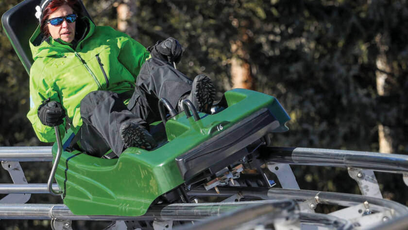 Lady in green riding mountain coaster