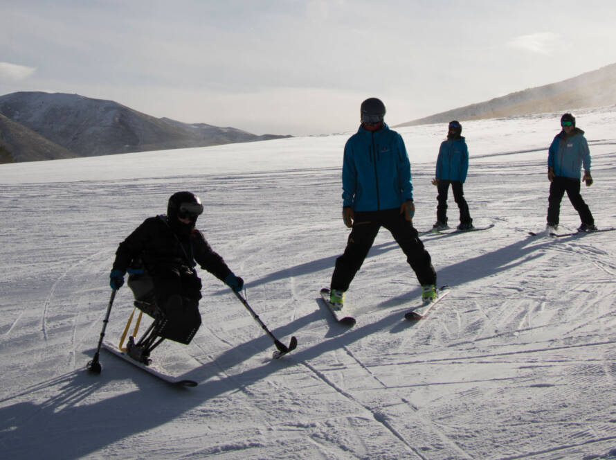 Skiers and snowboarders on sunny slope