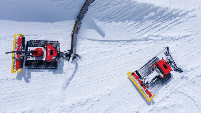 Snow grooming machines grooming the snow