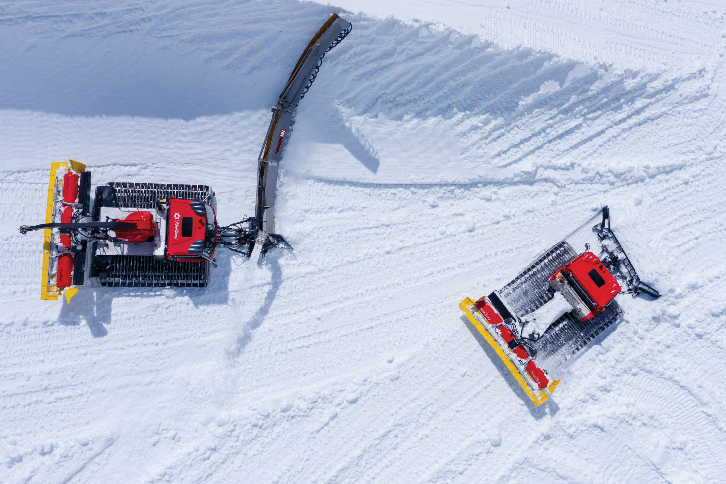 Snow grooming machines grooming the snow