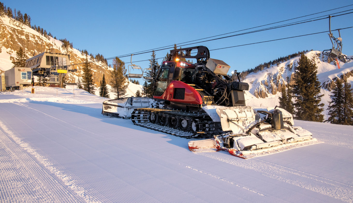 Winch Cat grooming machine parked at base of mountain