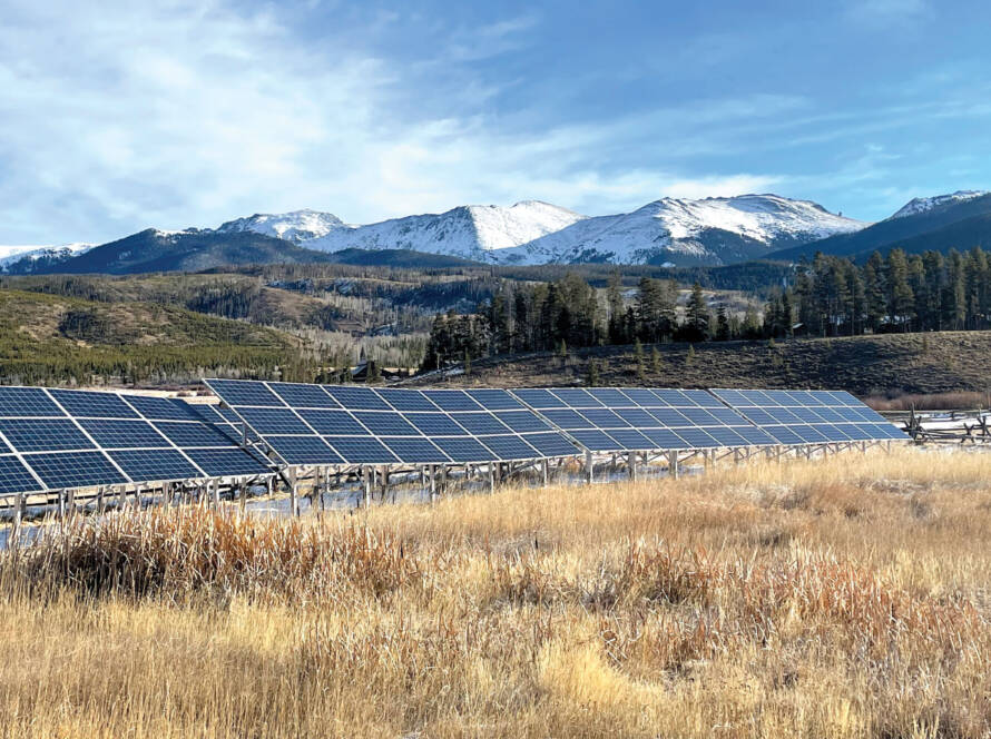 Solar panels with mountainside in background