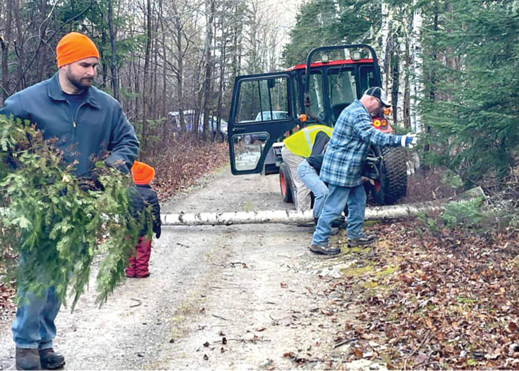 Volunteers clearing tree and branches from trail