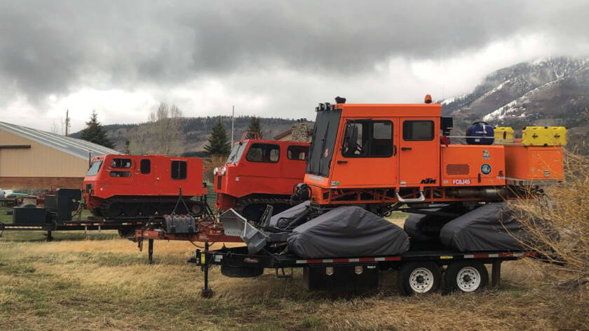 Snowcats sitting storage on trailers