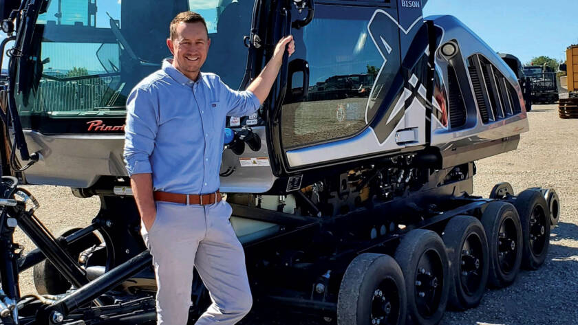 Photo of Scott Jones leaning against snow grooming equipment