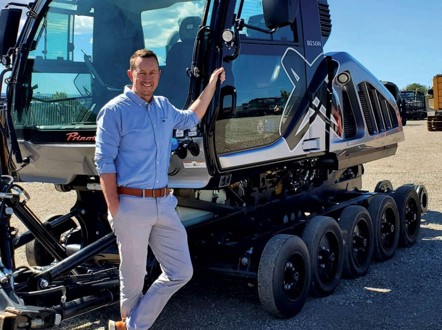 Photo of Scott Jones leaning against snow grooming equipment