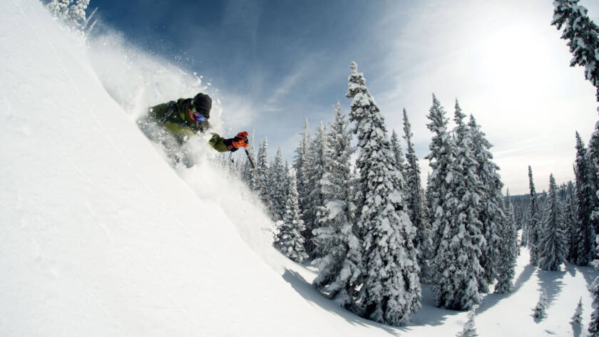 Skier skiing through fresh powder