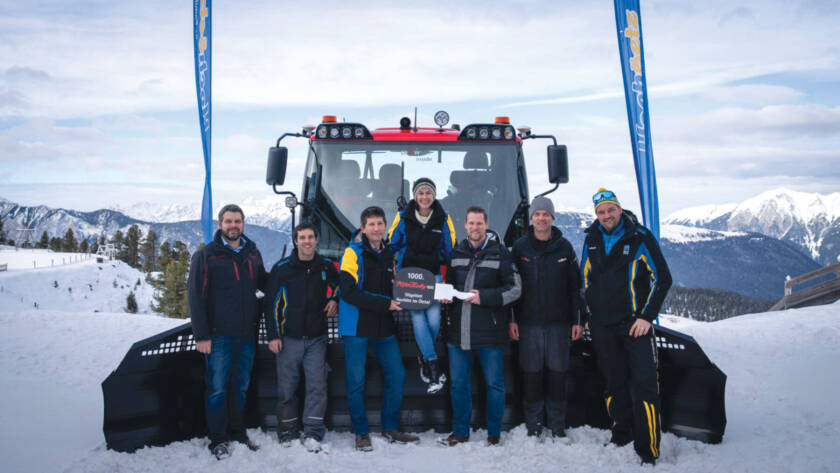 Sales rep, Managers, and Installer posing for photo in front of 1,000th PistenBully 600