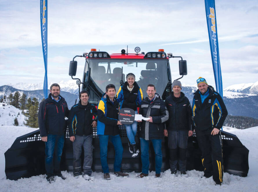 Sales rep, Managers, and Installer posing for photo in front of 1,000th PistenBully 600