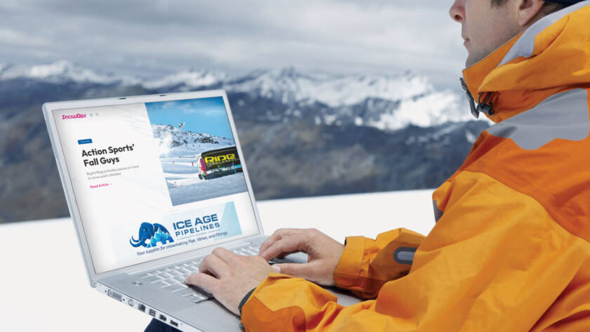 Snowboarder with laptop on mountain