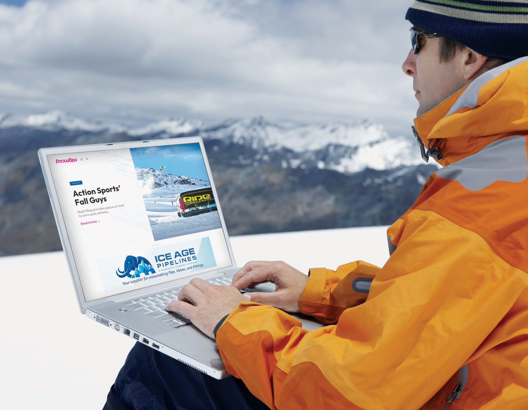 Snowboarder with laptop on mountain