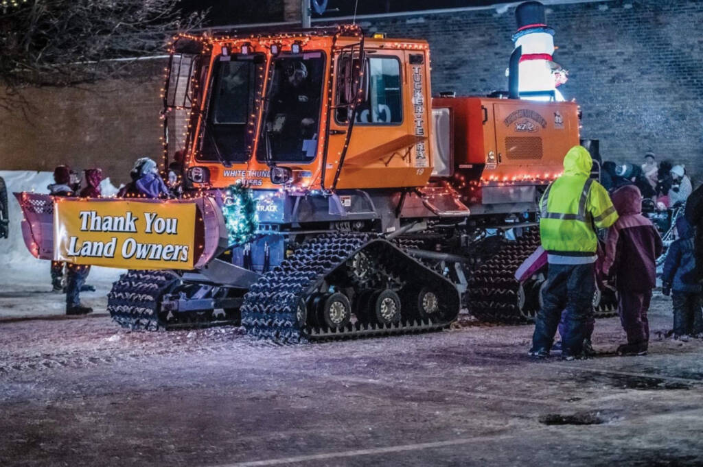 Sno-cat in parade with spectators