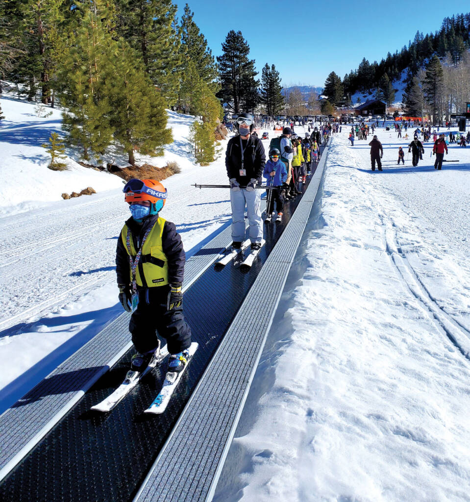 Kids and adults on carpet lift