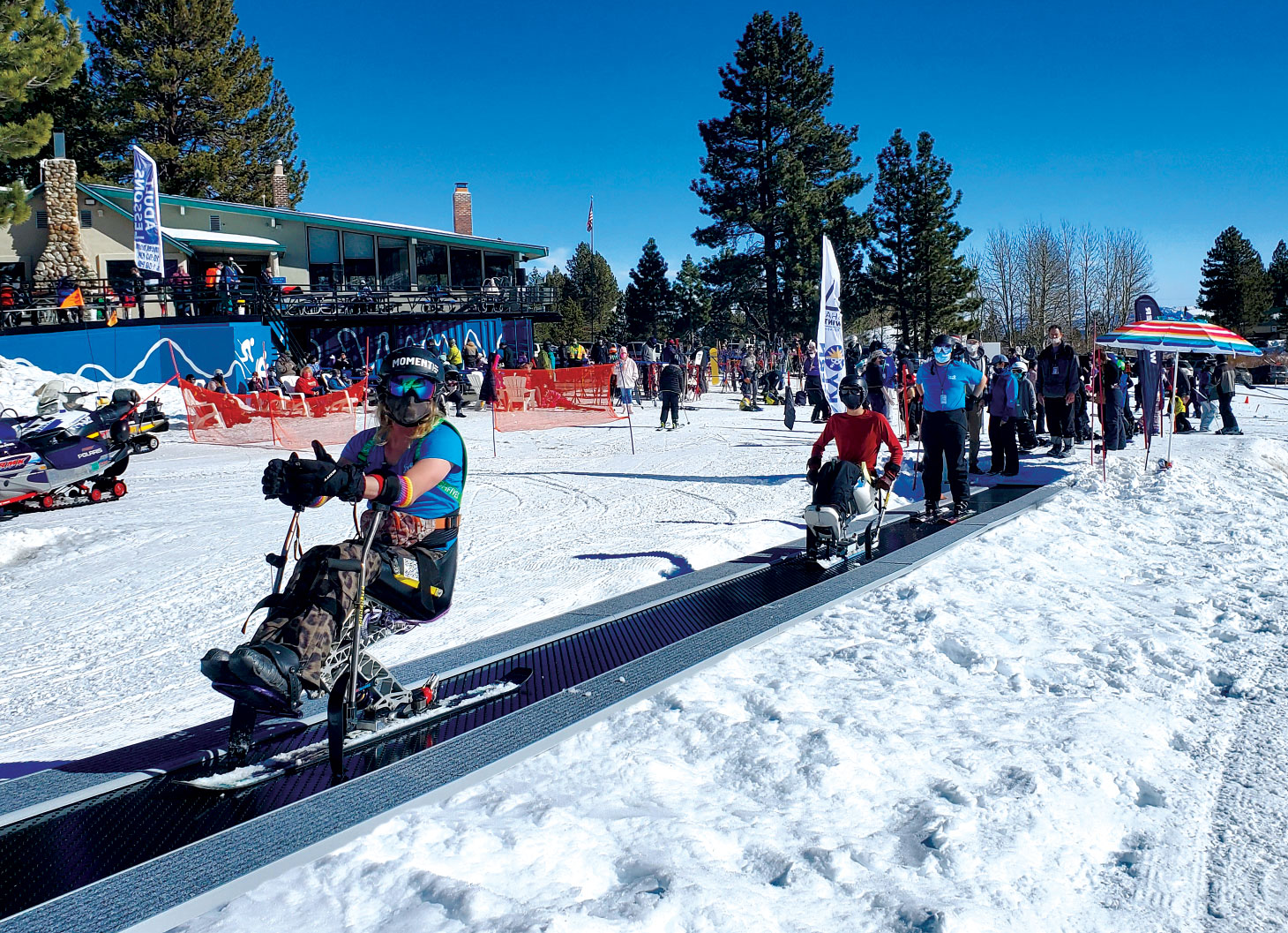 Skiers with disabilities on carpet lift