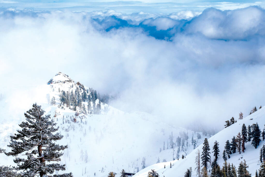 Snow covered mountaintops in clouds