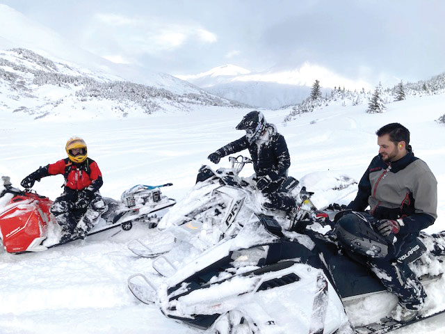 Snowmobilers on snowmobiles