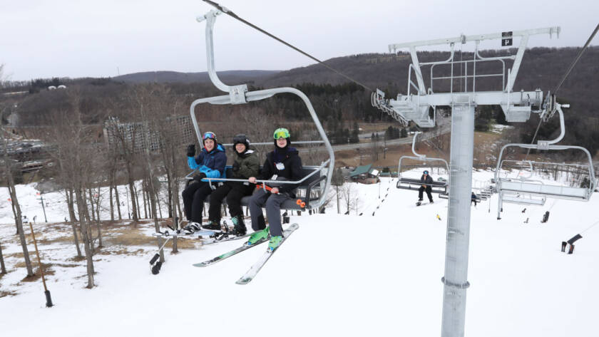 Three kids on ski lift