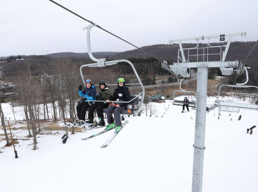 Three kids on ski lift