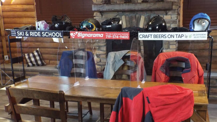 Table with signs on display and jackets on chairs