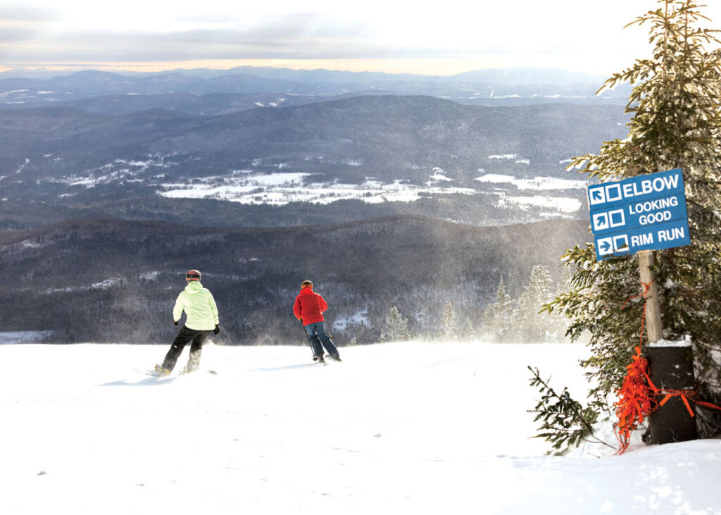 Snowboarder and skier