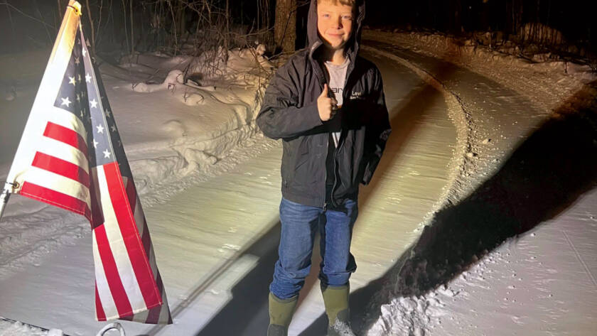 Levi giving thumbs up standing on trail