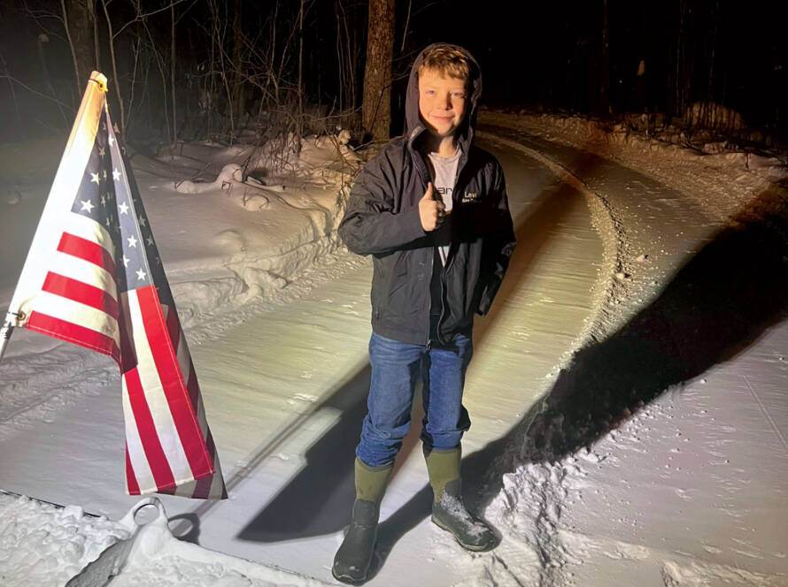 Levi giving thumbs up standing on trail