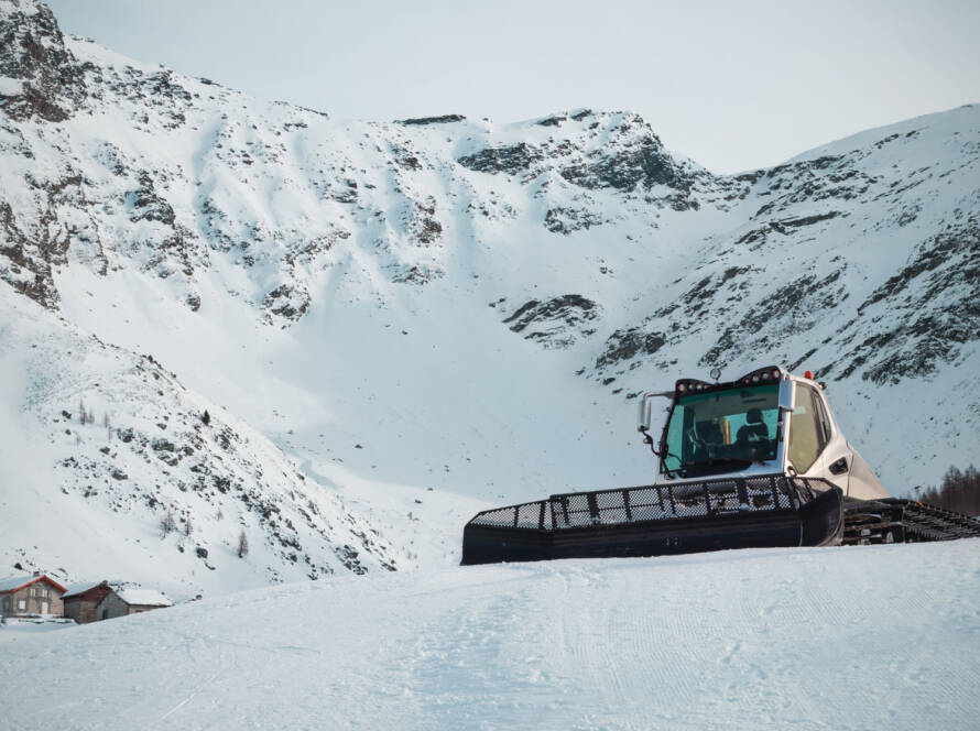 Snow groomer on snow-covered mountain