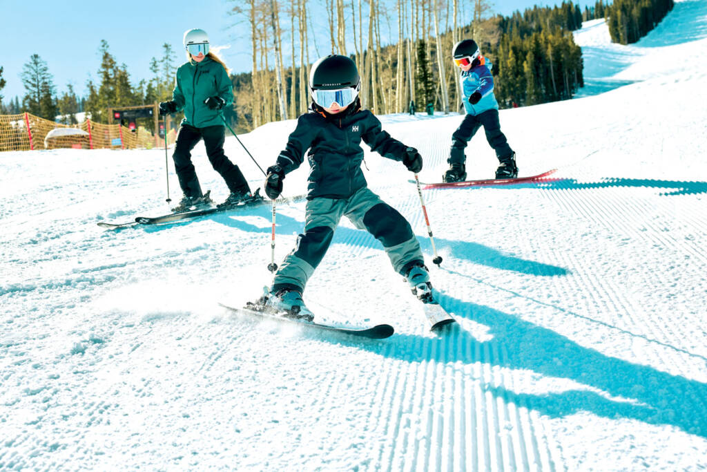 A woman and two kids skiing