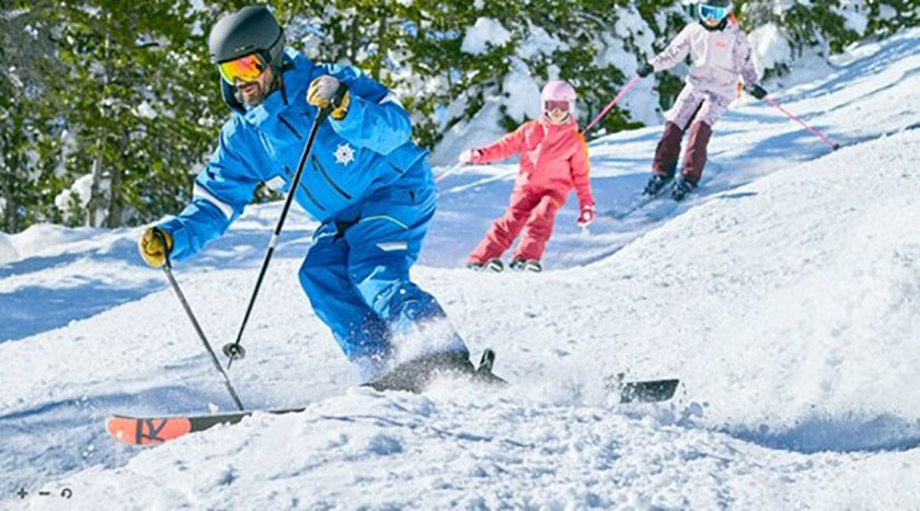 Couple with small child skiing