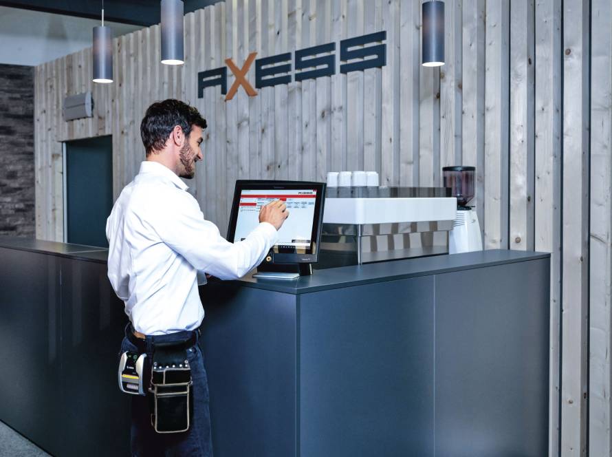 Employee using Axess software on touch screen