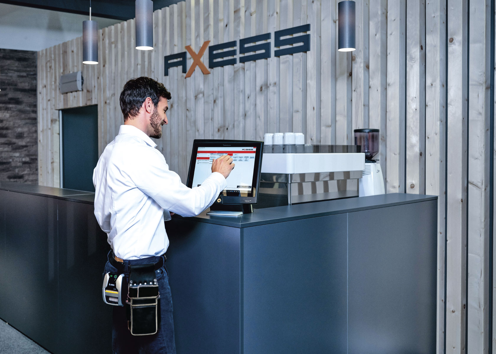 Employee using Axess software on touch screen