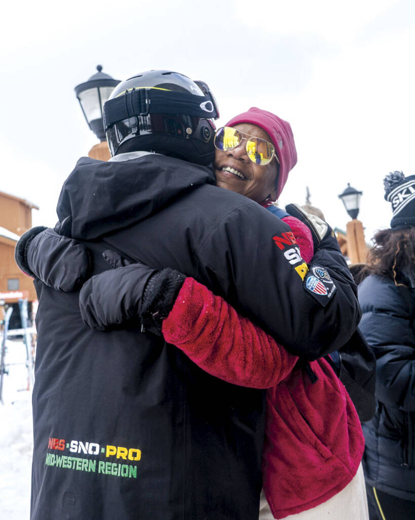 Two skiers hugging