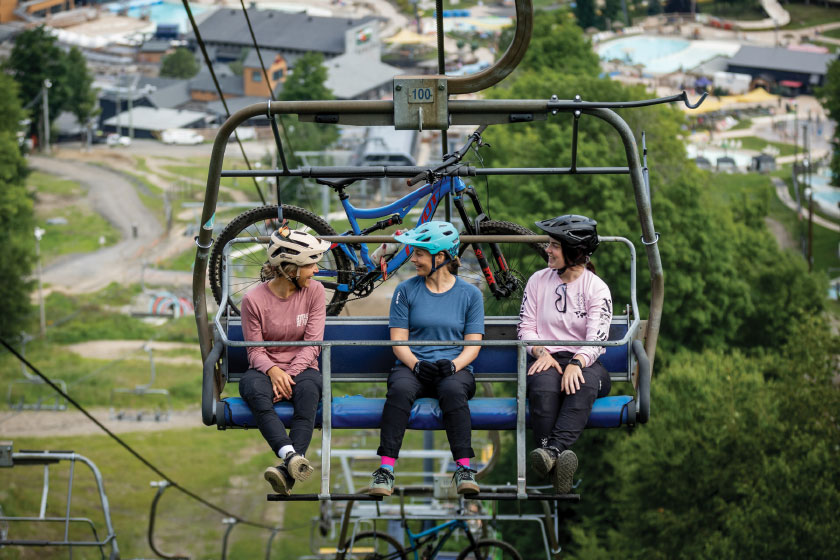 Three people seated on gondola