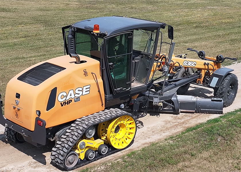 Grader fitted with Mattracks TD300 working on rural road