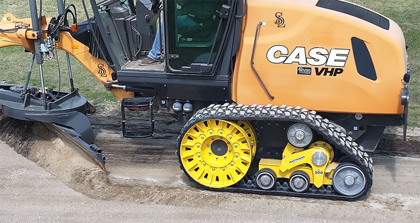 Grader fitted with Mattracks TD300 working on rural road