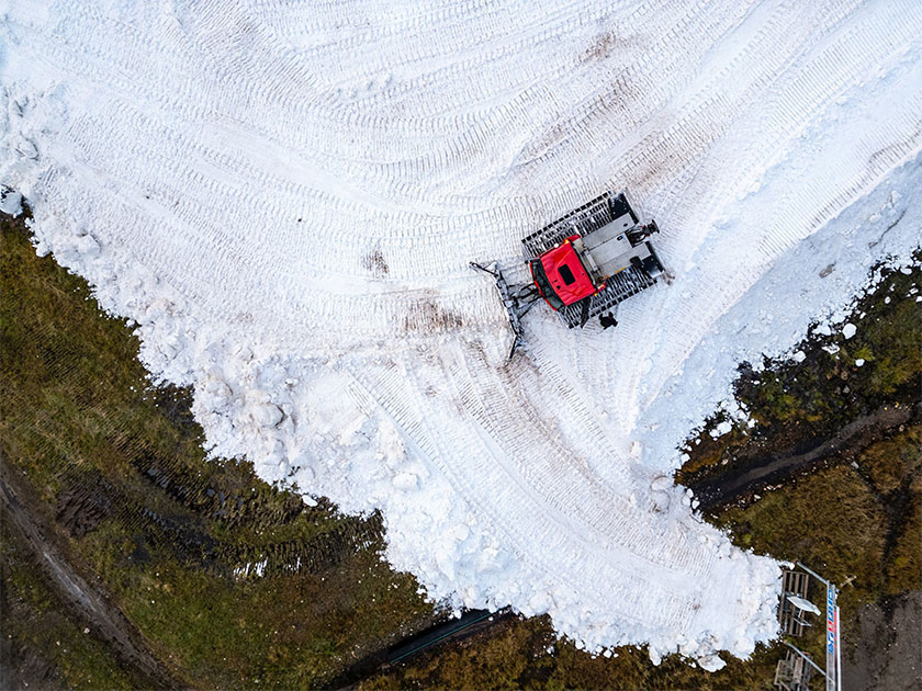 Snow groomer preparing snow for Snow Secure’s storage system