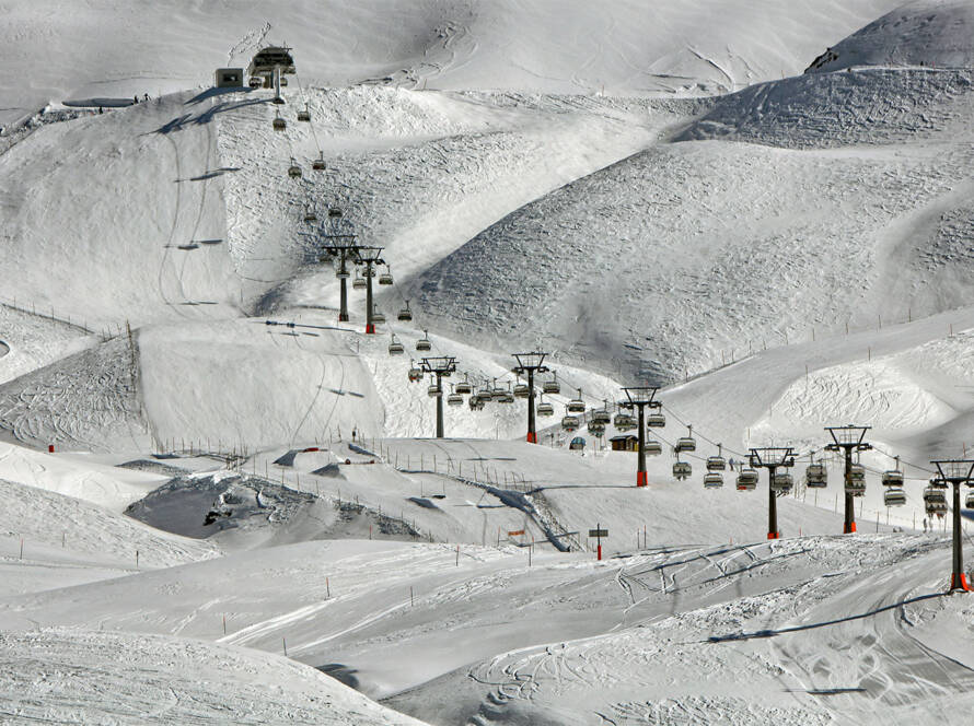 Aerial view of ski lift carrying passengers up mountain