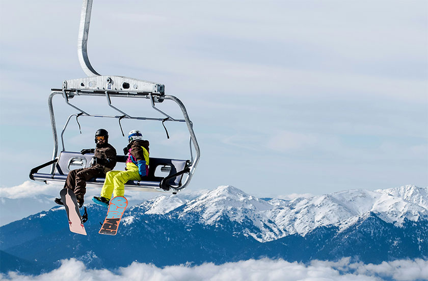 Two snowboarders on ski lift