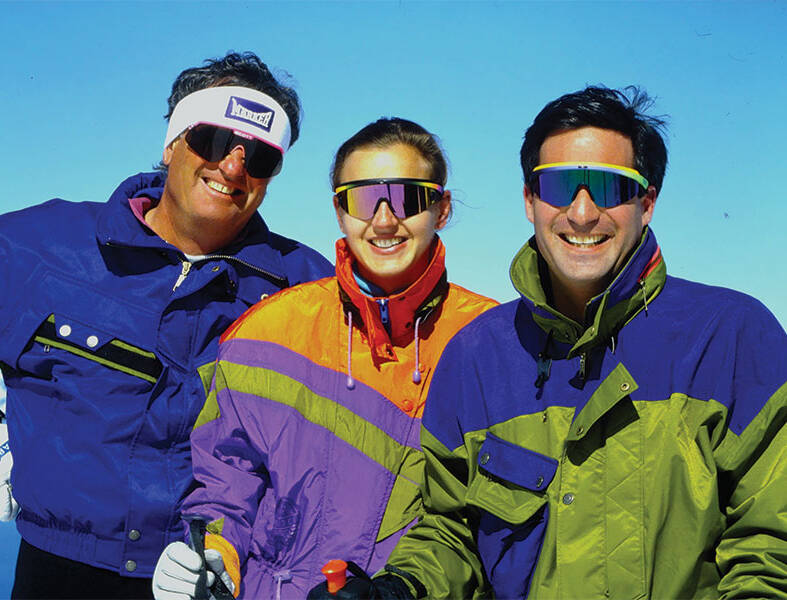 Three skiers smiling for photo