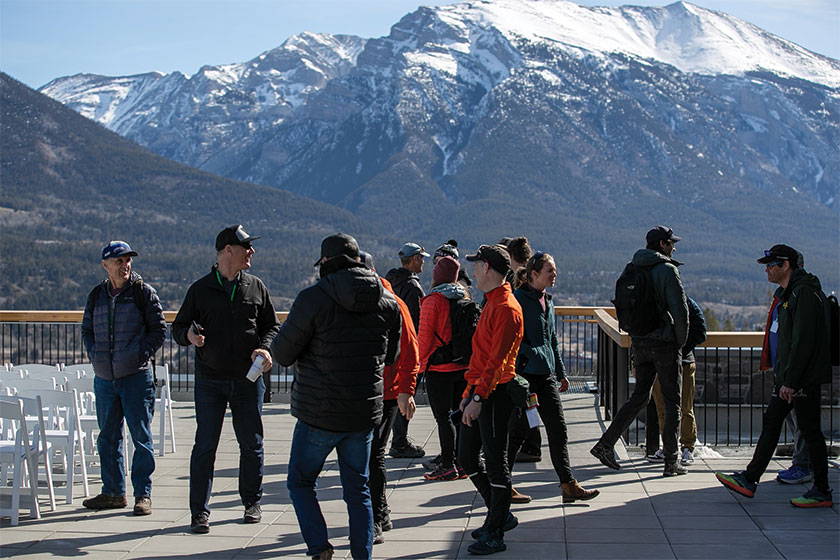 Group on patio, with snow-capped mountains in background