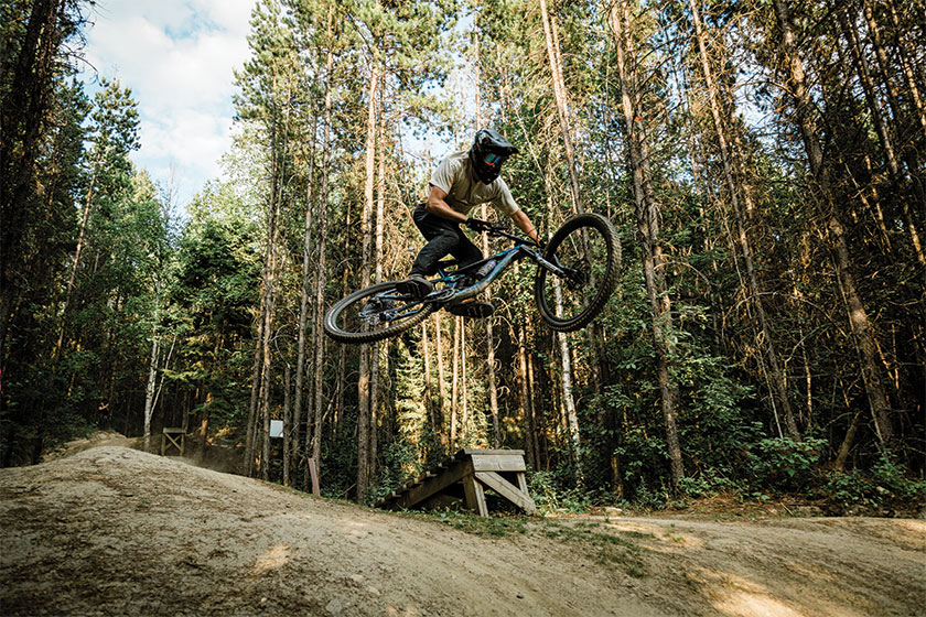 Biker on trail making jump